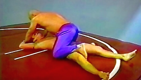 1980s wrestling match with a tattooed brunette girl
