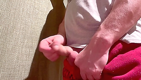 Horny guy has a long dick and he jerks it in the bedroom